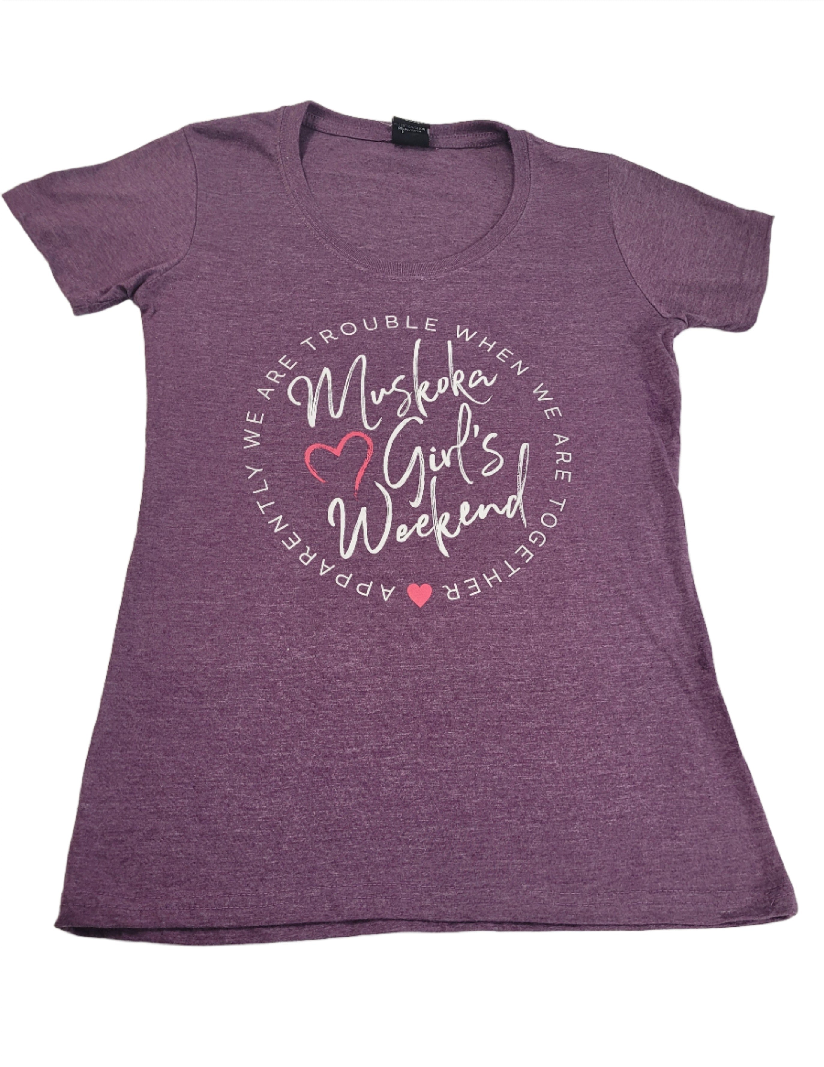 A purple short-sleeved t-shirt with the text 'Muskoka Girls Weekend' printed on the front.