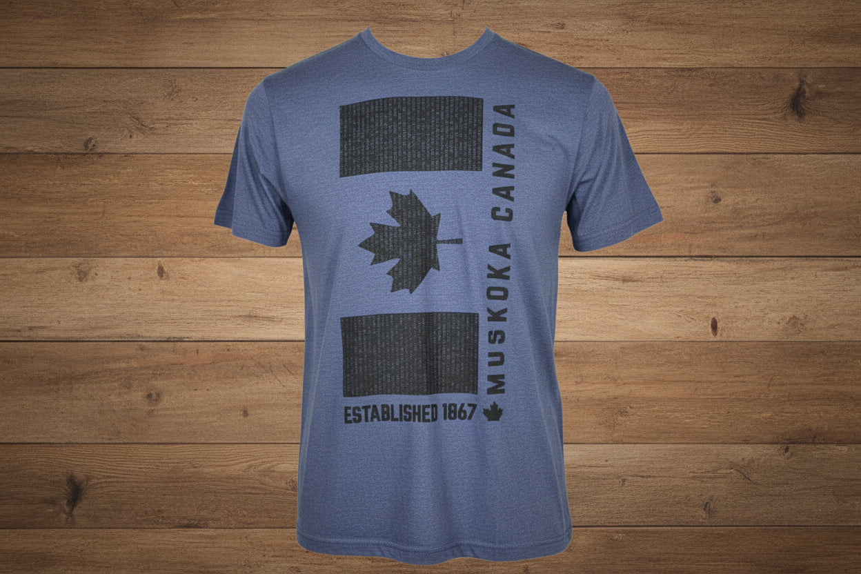 Blue t-shirt with black graphics and text on a gray surface