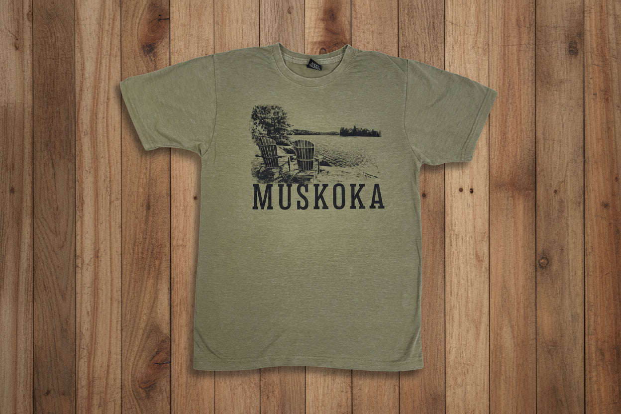A green T-shirt with the text 'MUSKOKA' printed on it and an image of a chair and trees near a lake.