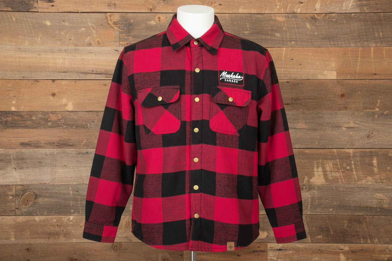 Red and black checkered shirt with a brand logo on a wooden surface