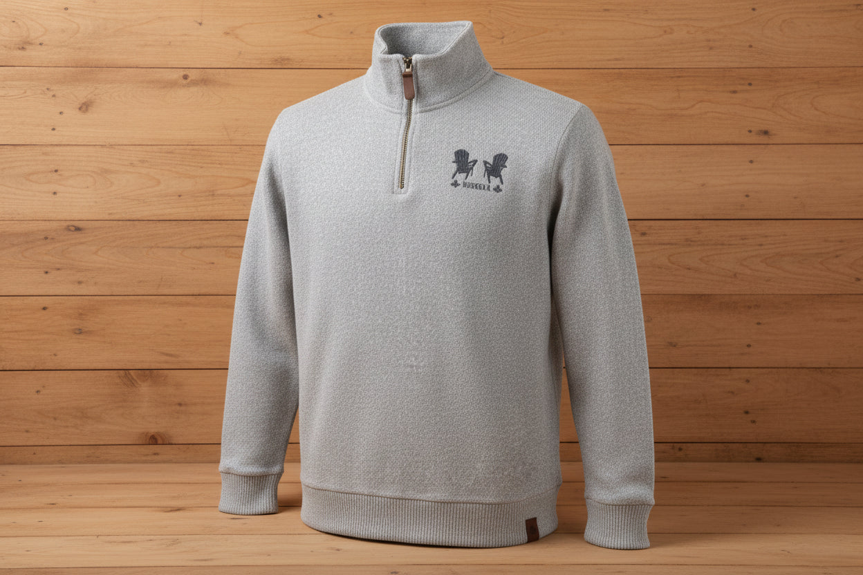 A grey quarter zip sweater with a small logo on the upper left side, made of cotton and polyester, displayed on a white background.