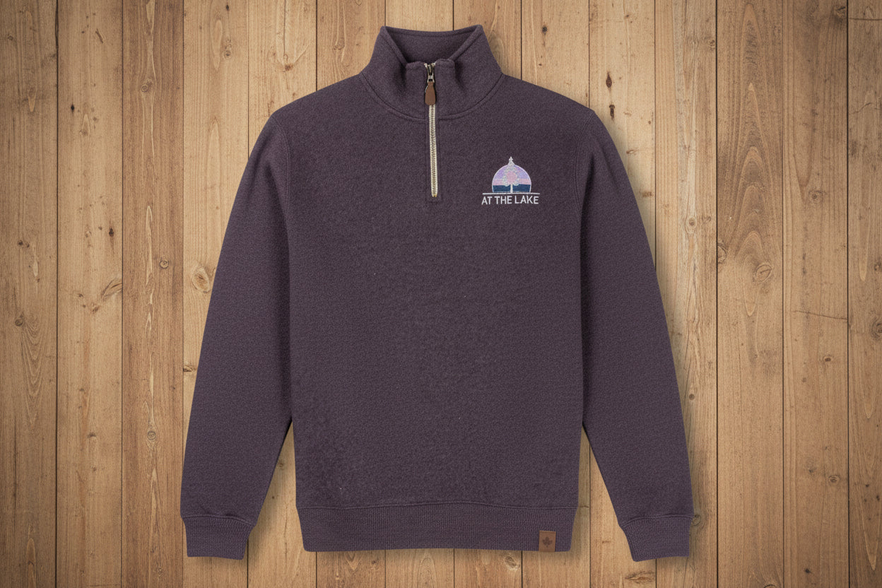 A purple Nantucket quarter zip sweater with a small logo on the chest.