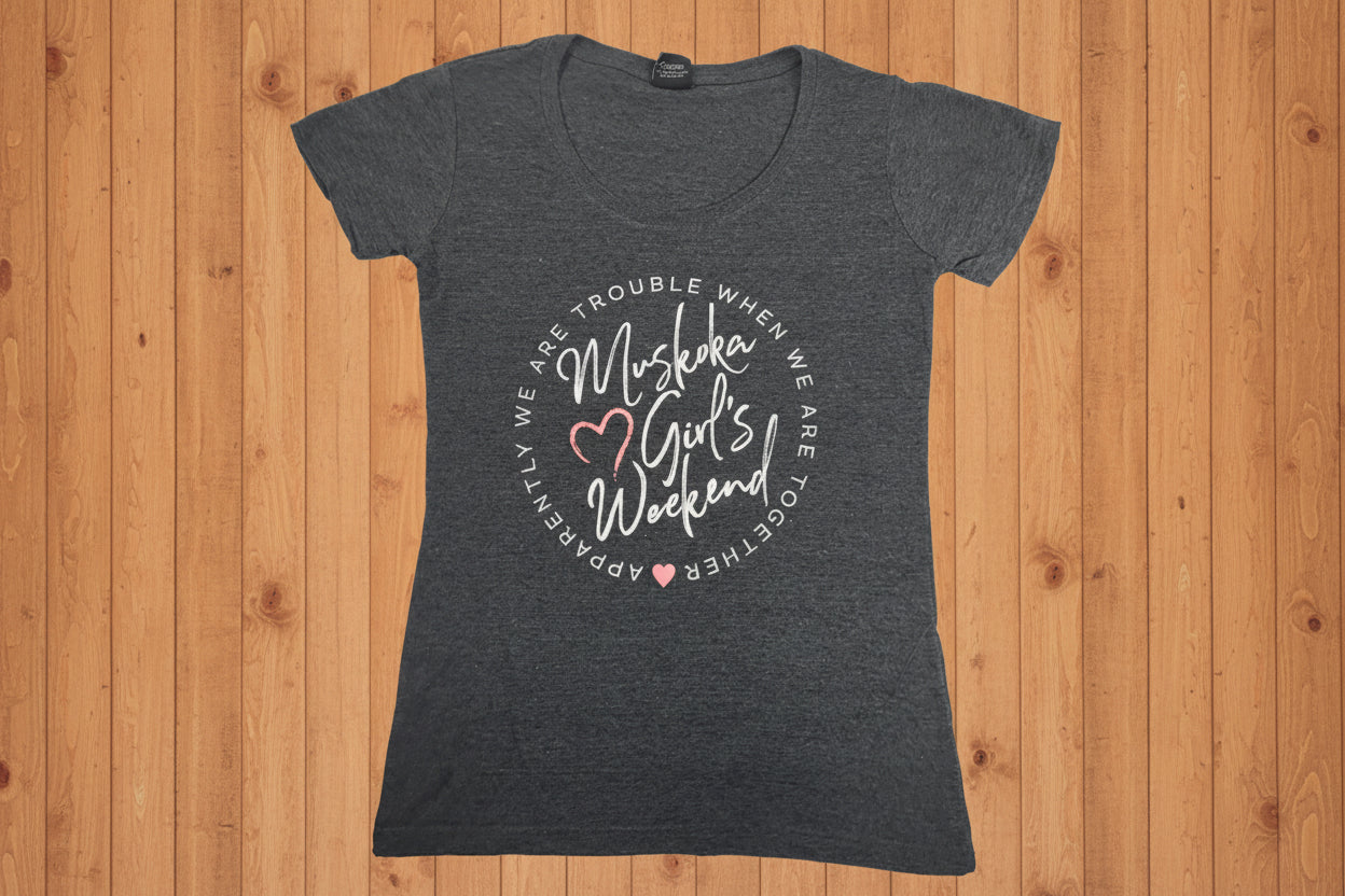 A gray t-shirt with the text 'Muskoka Girls Weekend' printed on the front.