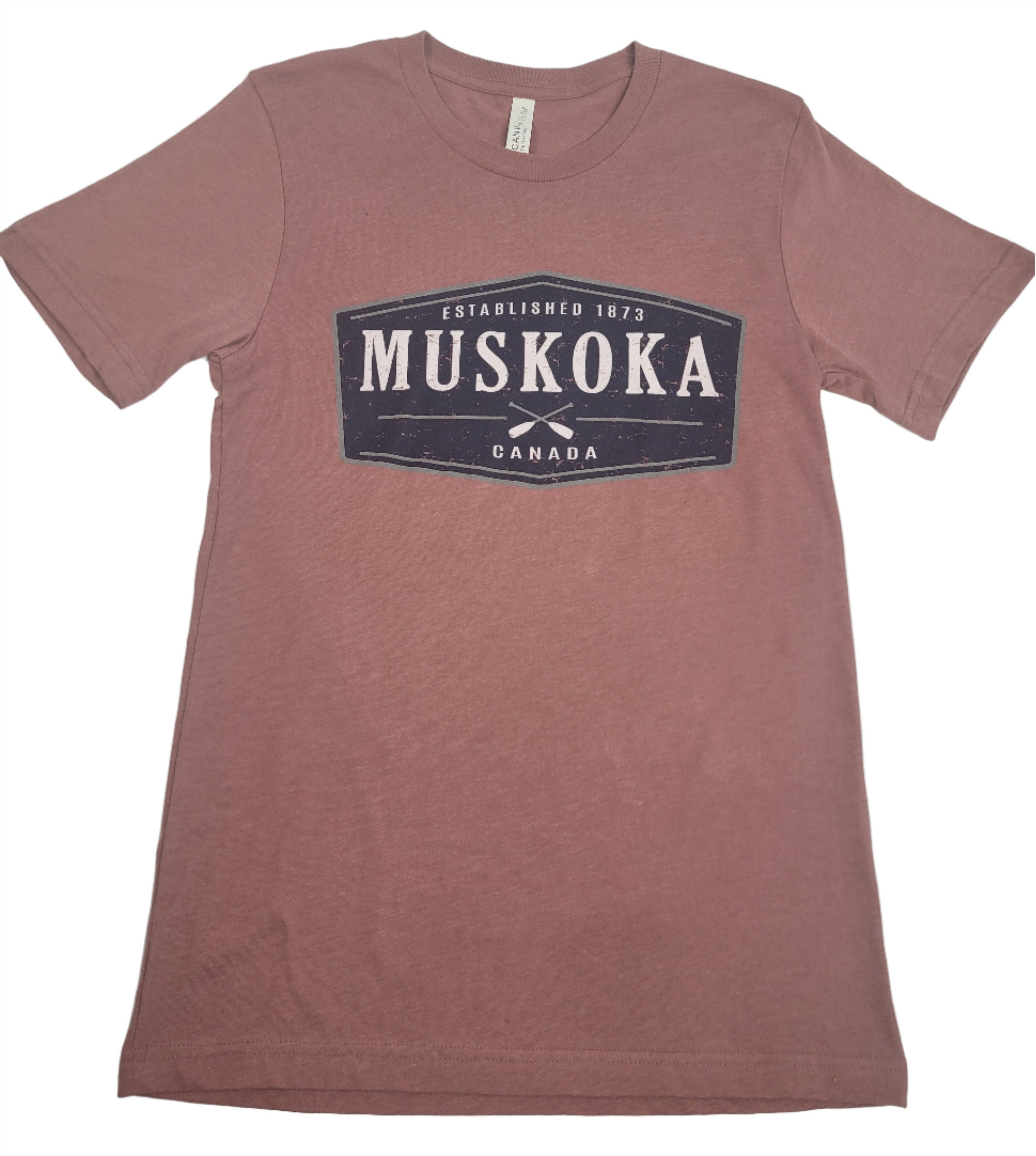 Heathered red T-shirt with 'MUSKOKA' written on the front in bold letters, above a smaller text that reads 'CANADA'.